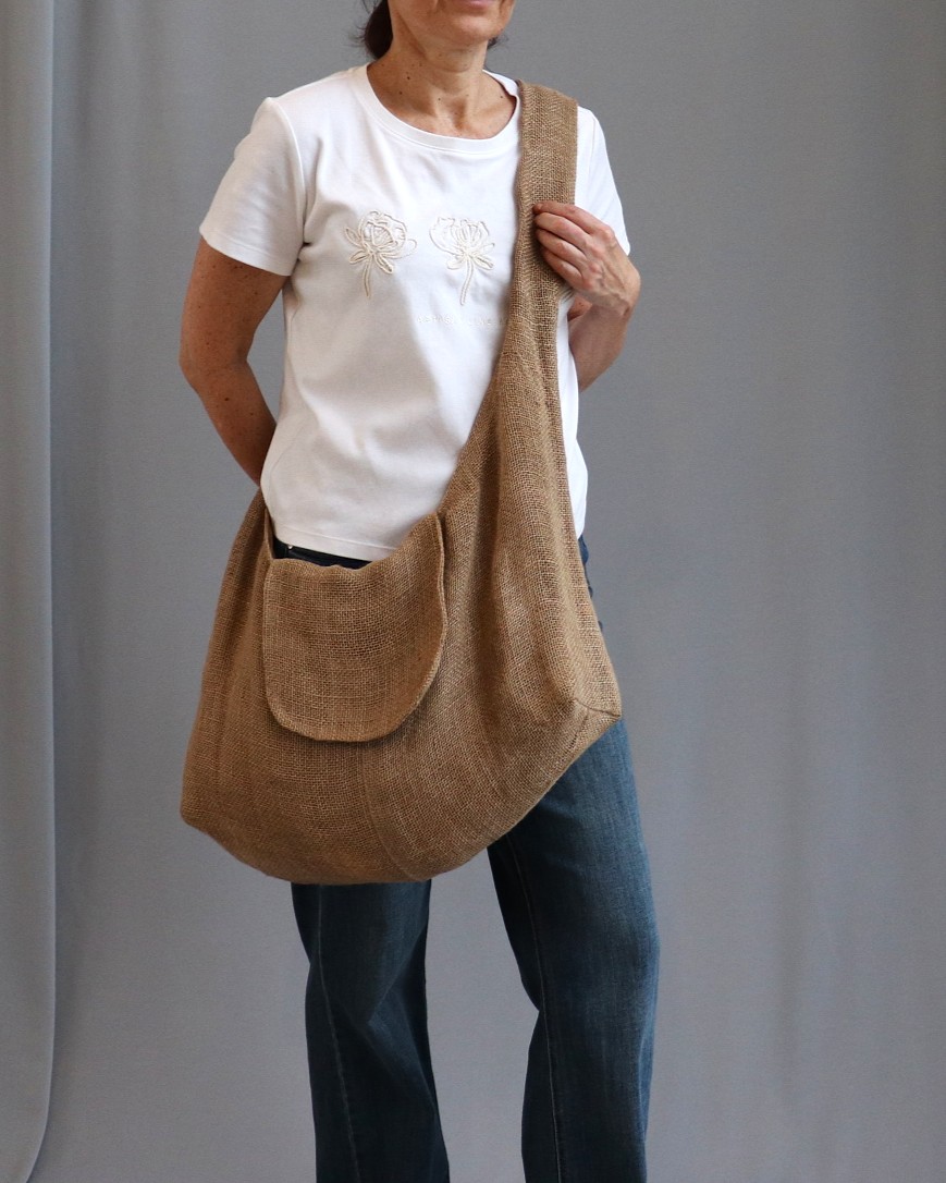 Slouchy hobo shoulder bag with a long strap and front flap handmade fabric boho bag displayed against a neutral background.