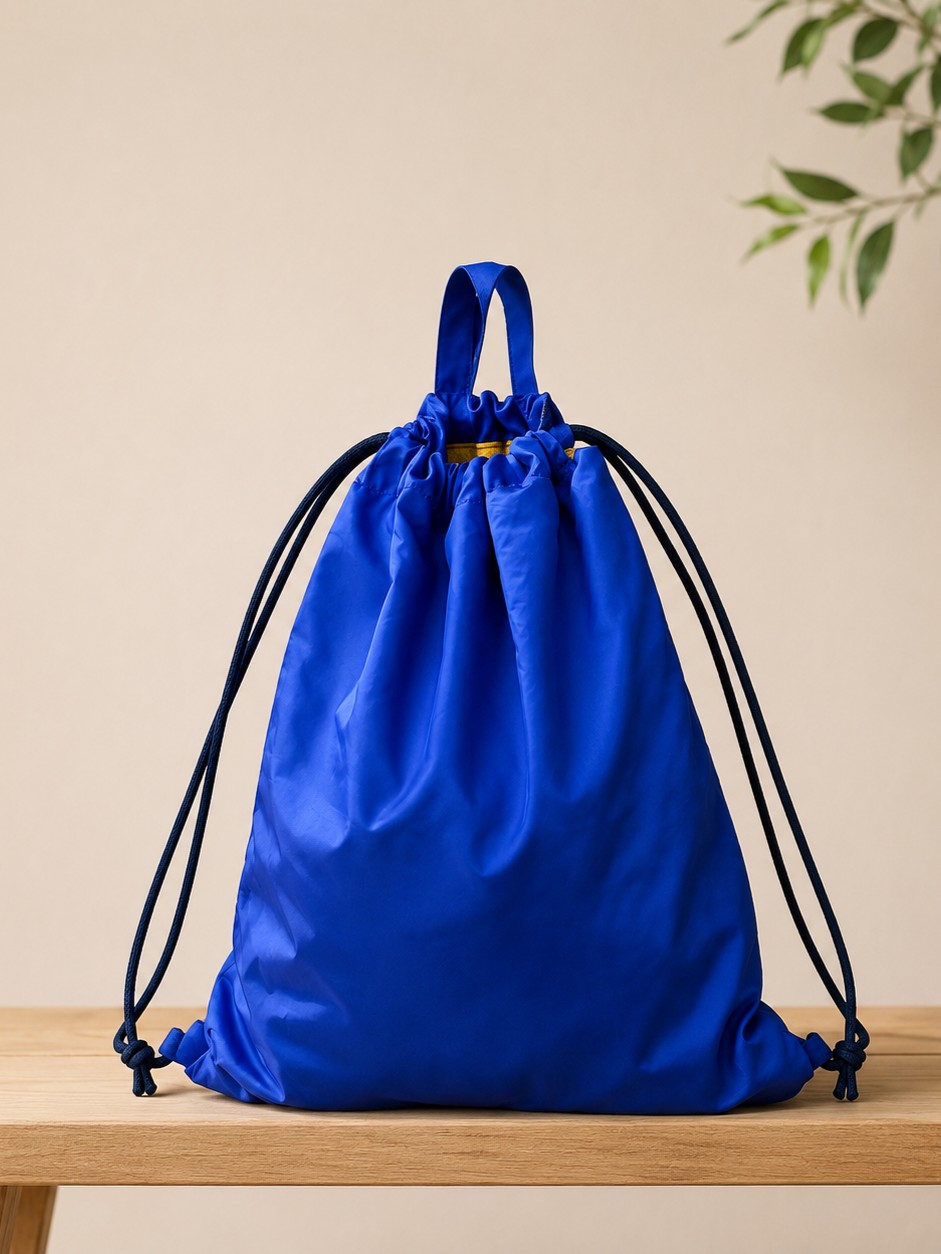 blue drawstring bag /backpack on the bench